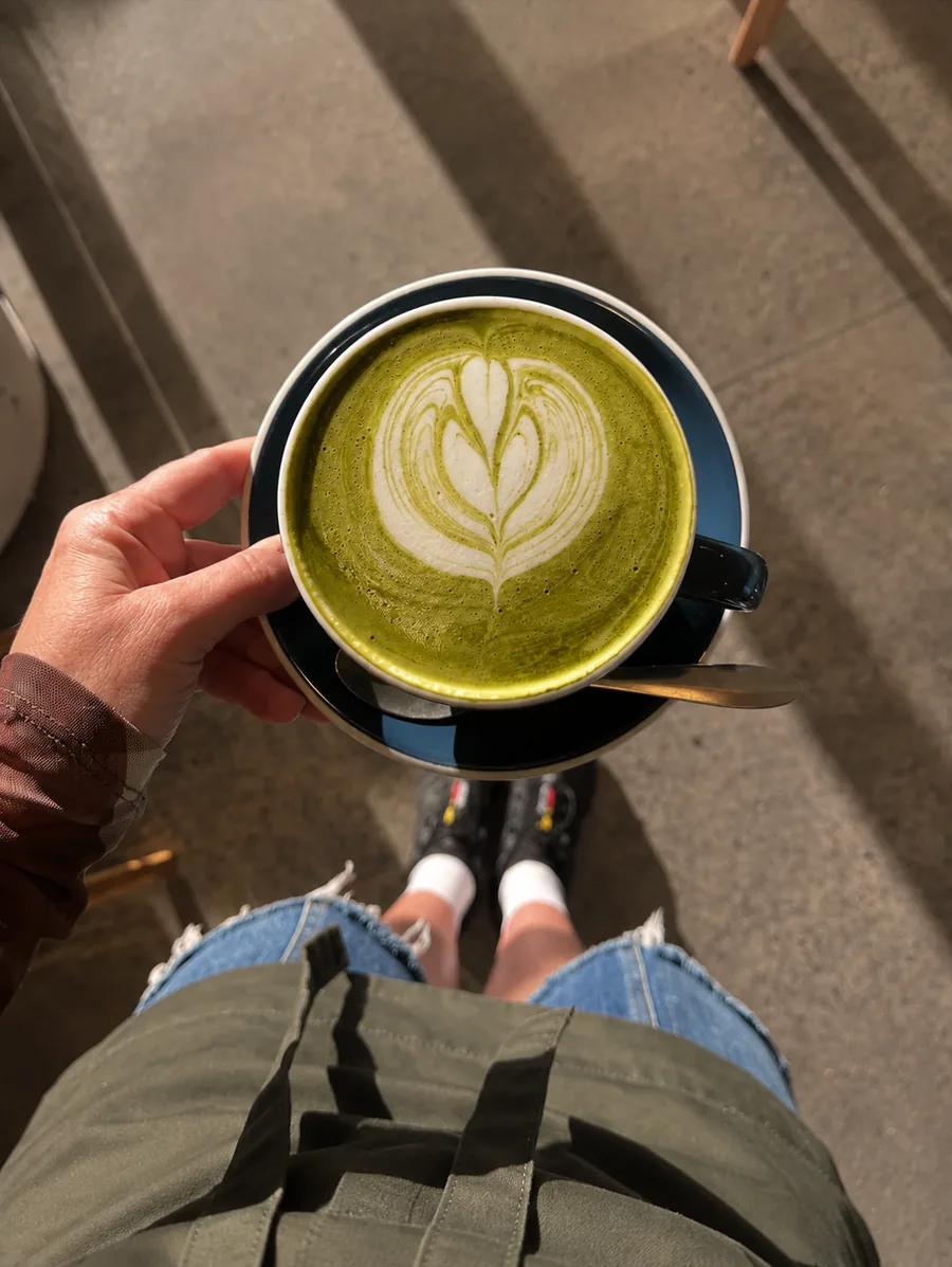 Green matcha latte in a blue cup