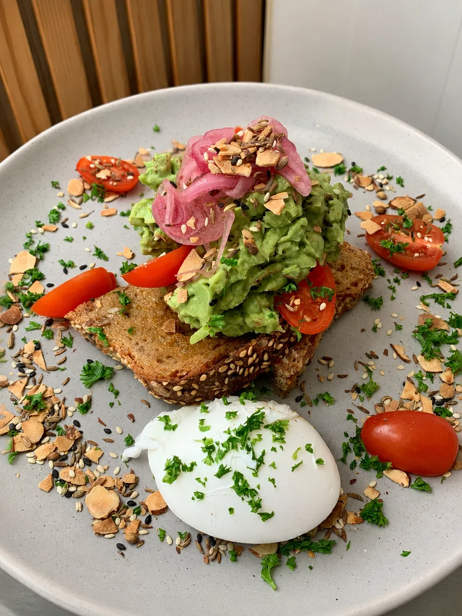 A colourful breakfast plate with avocado and tomatoes